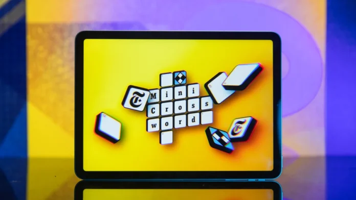 NYT Mini Crossword game displayed on a tablet screen with a vibrant yellow background