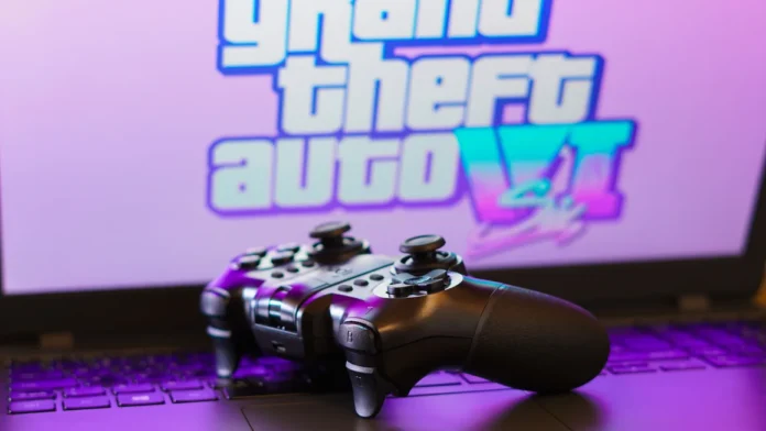 Gaming controller resting on a laptop with the Grand Theft Auto VI logo on screen