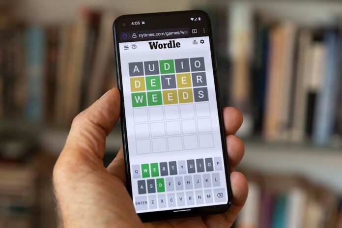 Smartphone screen displaying the Wordle game with guesses AUDIO, DETER, and WEEDS highlighted in green, yellow, and gray.
