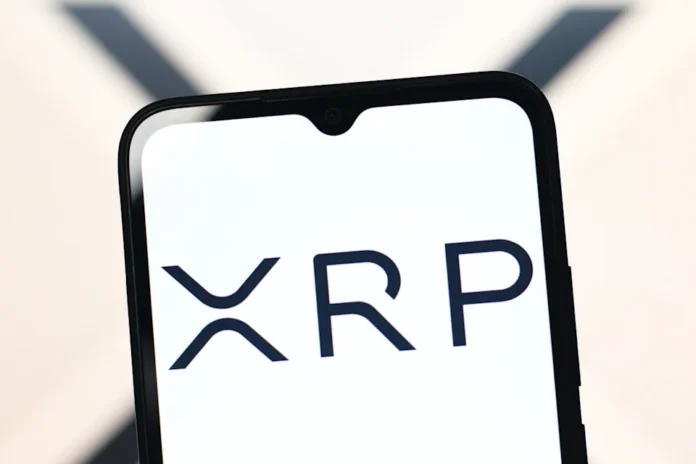 XRP logo on a smartphone screen, reflecting Ripple’s cryptocurrency and Chris Larsen’s large XRP transfers during the 2025 rally.