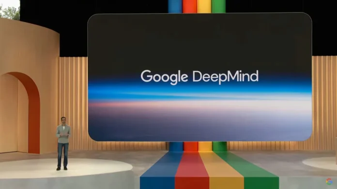 Sundar Pichai onstage at Google I/O 2025 with a screen showing the Google DeepMind logo, introducing AI-powered bug discovery tool Big Sleep.